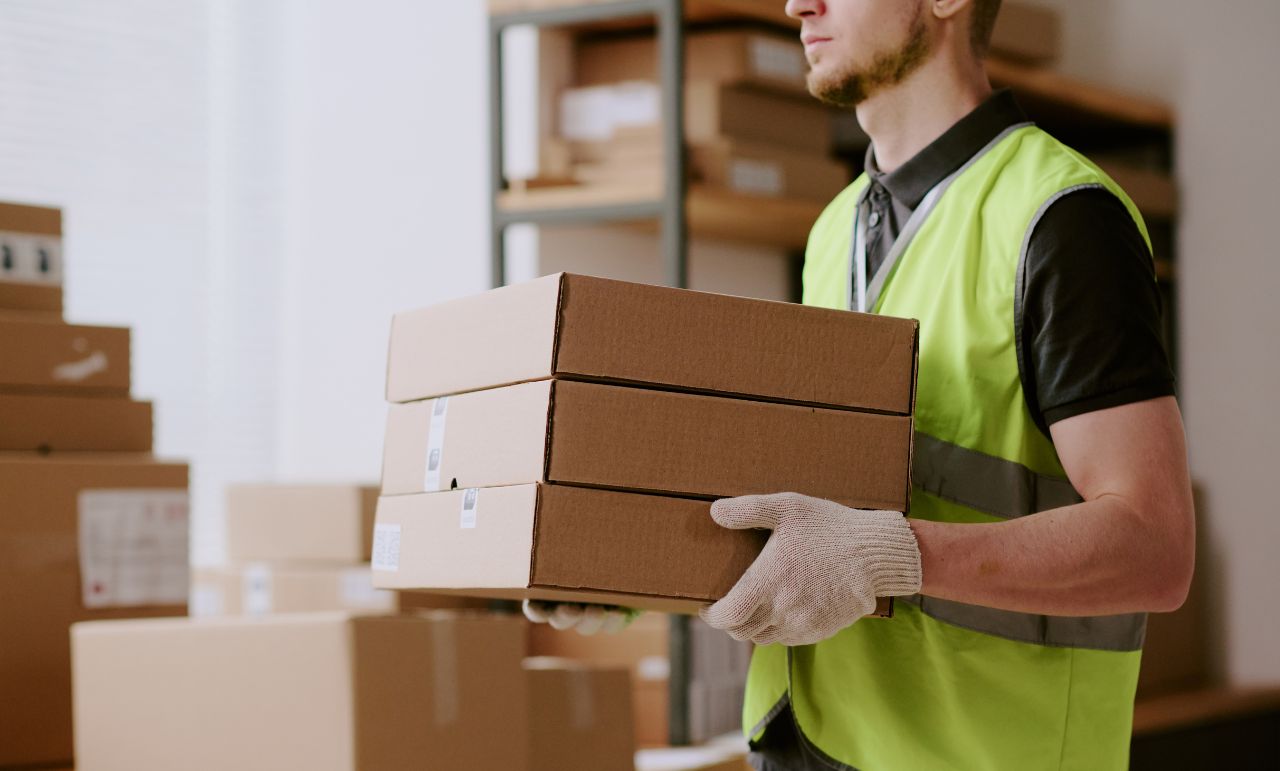 Warehouse worker carrying boxes safely